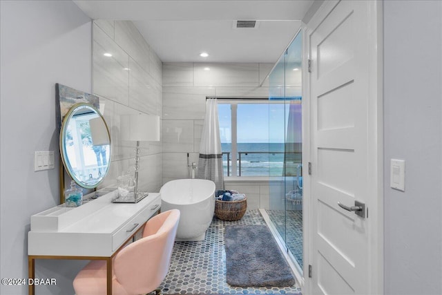 bathroom featuring plus walk in shower and a water view