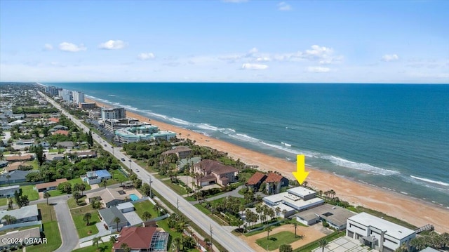 birds eye view of property with a view of the beach and a water view