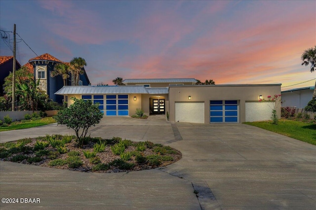 717 Ocean Shore Blvd, Ormond Beach, FL 32176 - view of front of home with stucco siding, driveway, a garage, and french doors