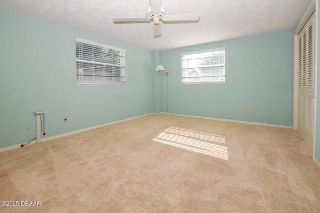 unfurnished bedroom with light colored carpet, ceiling fan, and a closet