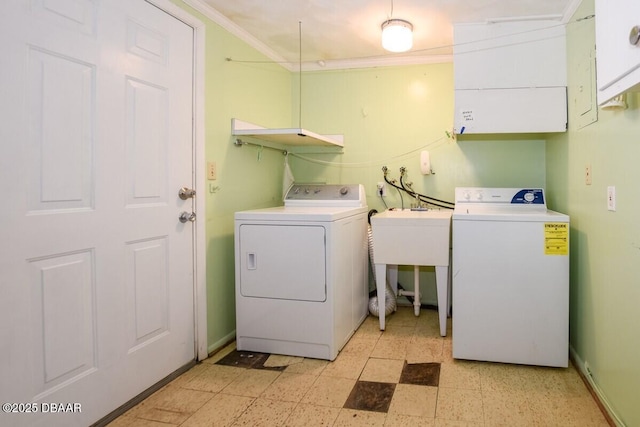 laundry room featuring ornamental molding and washer and clothes dryer