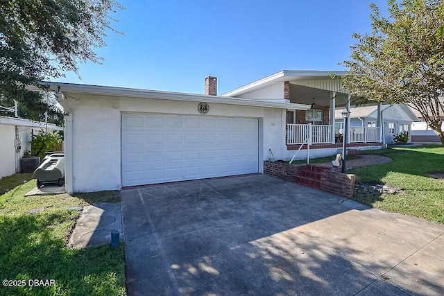 view of front facade with a garage, covered porch, and a front lawn