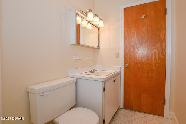 bathroom featuring vanity, tile patterned floors, and toilet