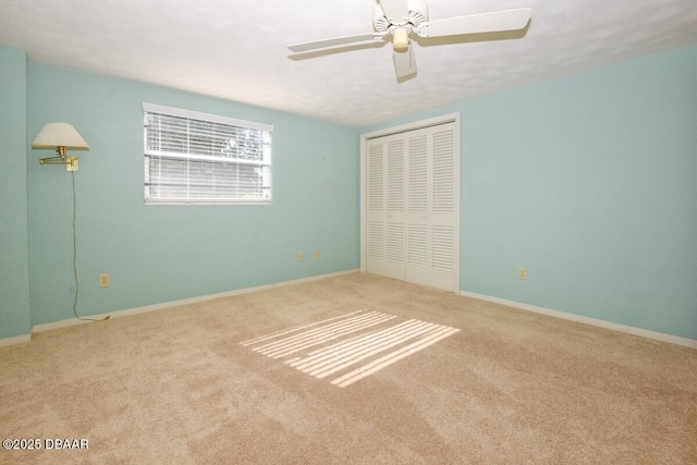 unfurnished bedroom with light carpet, a closet, and ceiling fan