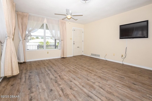 unfurnished living room featuring hardwood / wood-style flooring and ceiling fan