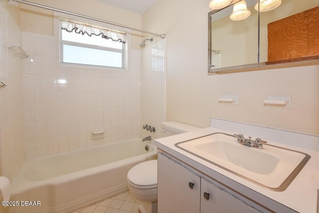 full bathroom featuring vanity, tiled shower / bath combo, tile patterned floors, and toilet