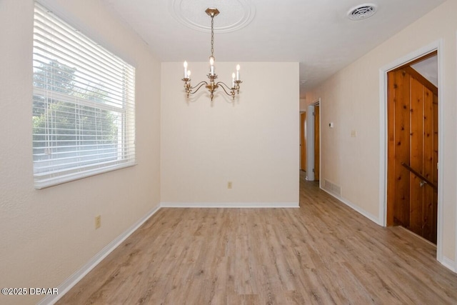 interior space with a chandelier and light hardwood / wood-style floors