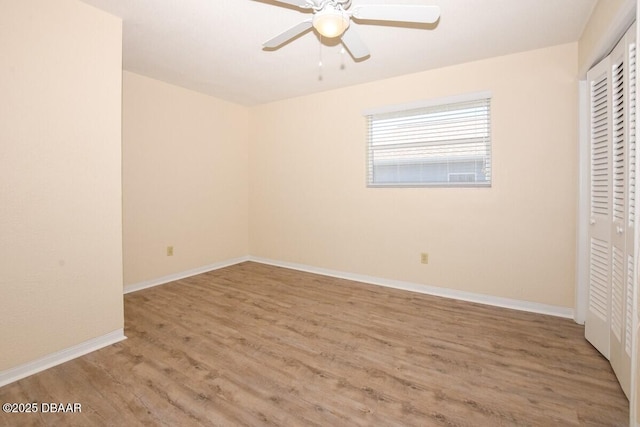 unfurnished bedroom featuring light hardwood / wood-style flooring, a closet, and ceiling fan