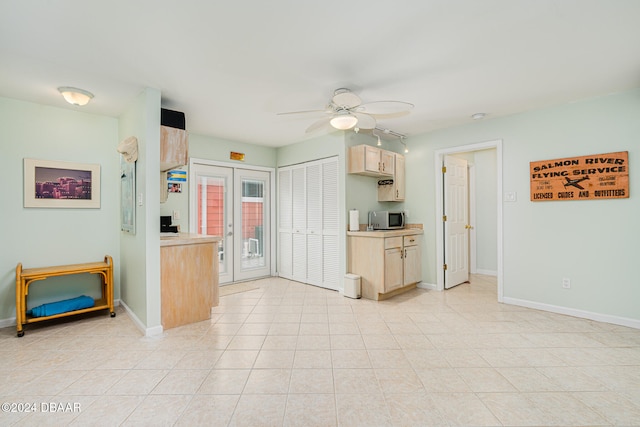 kitchen featuring ceiling fan, light tile patterned flooring, light brown cabinetry, and french doors