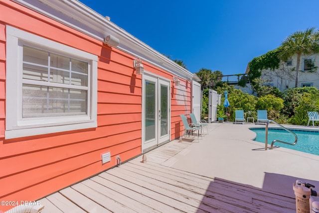 wooden deck with a fenced in pool