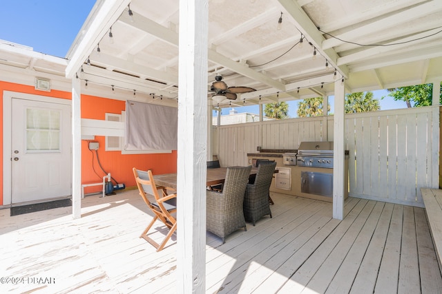 wooden deck with ceiling fan and a grill