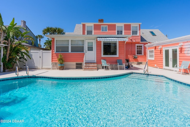 view of pool featuring french doors and a patio area