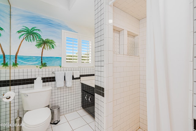 bathroom featuring tile patterned floors, toilet, and tile walls