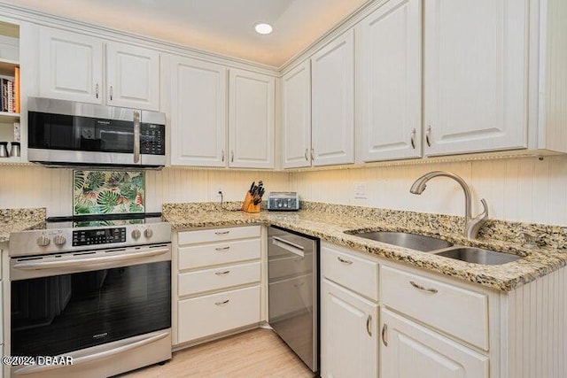 kitchen featuring white cabinets, sink, and stainless steel appliances