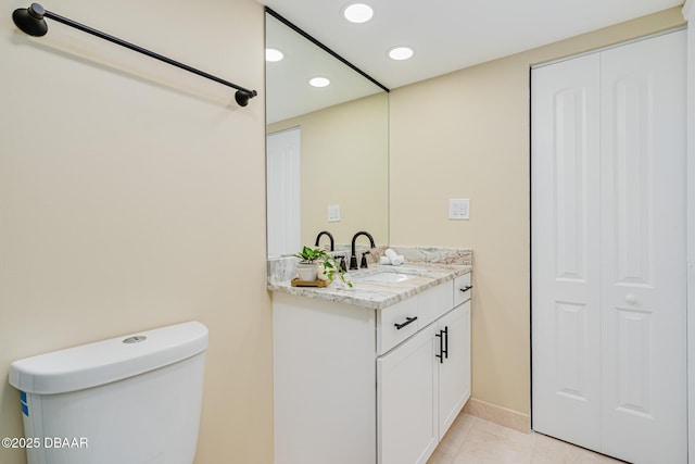 bathroom featuring recessed lighting, toilet, vanity, and tile patterned floors