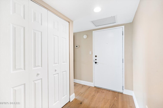 interior space featuring baseboards and light wood-style floors