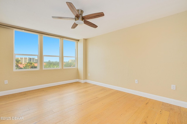 empty room with light wood-style flooring, baseboards, and ceiling fan