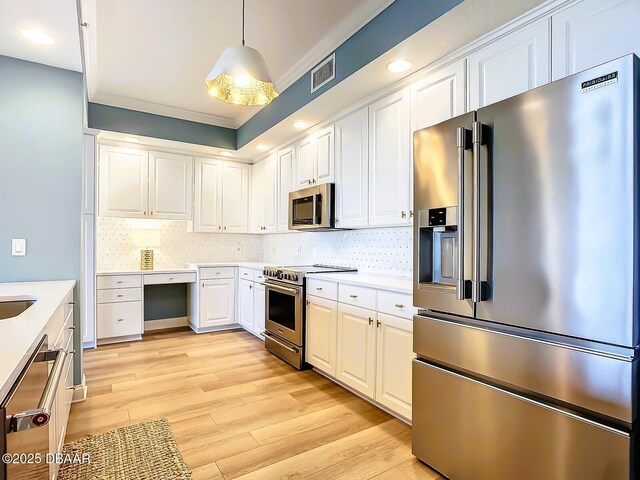 spare room with plenty of natural light, a textured ceiling, and light wood-type flooring