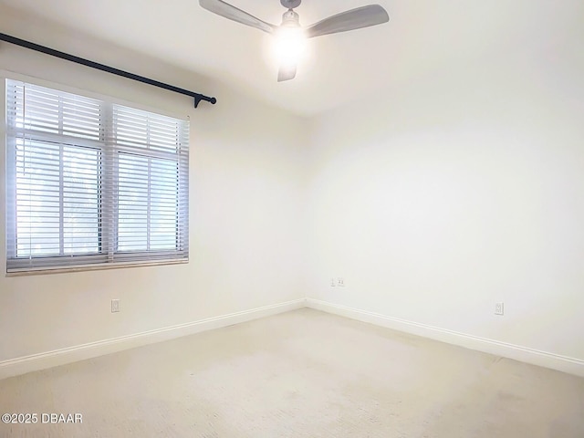 unfurnished room featuring baseboards, ceiling fan, and carpet flooring