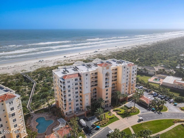 birds eye view of property featuring a water view and a beach view