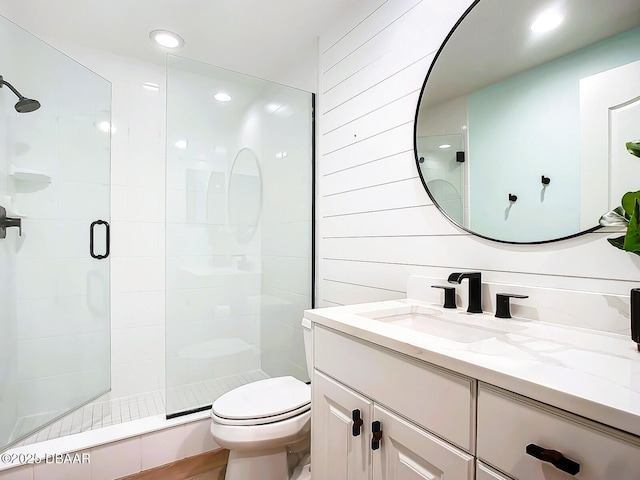 bathroom featuring recessed lighting, vanity, toilet, and a shower stall