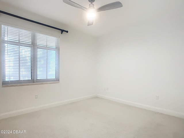 spare room featuring carpet flooring and ceiling fan