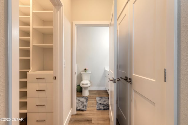 bathroom featuring hardwood / wood-style floors and toilet