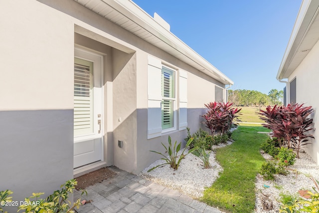 doorway to property with a yard