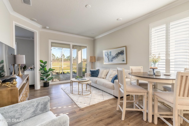 living room featuring wood-type flooring and ornamental molding