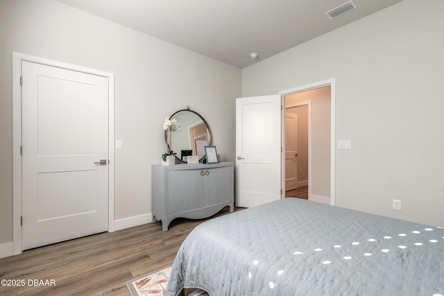 bedroom with hardwood / wood-style floors