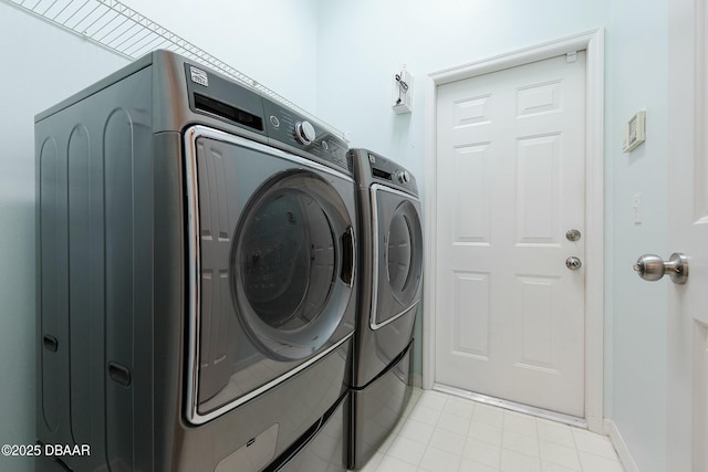 laundry area featuring laundry area, washer and clothes dryer, and baseboards