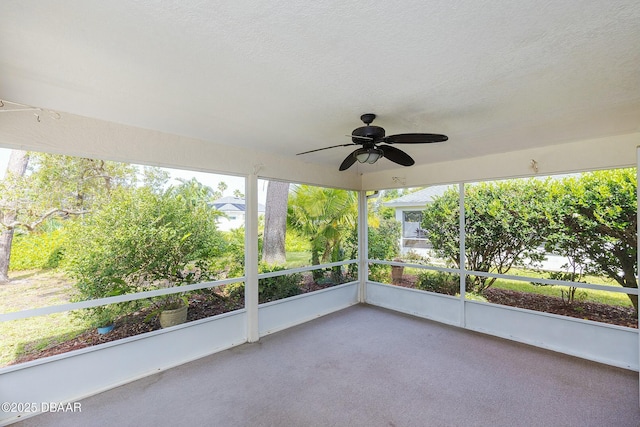 unfurnished sunroom featuring a ceiling fan