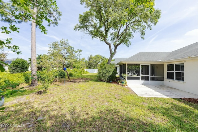 view of yard featuring fence, a patio, and a sunroom