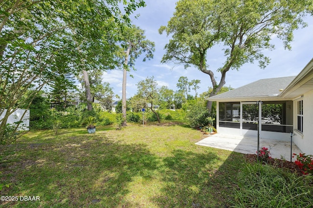 view of yard featuring a patio area and a sunroom