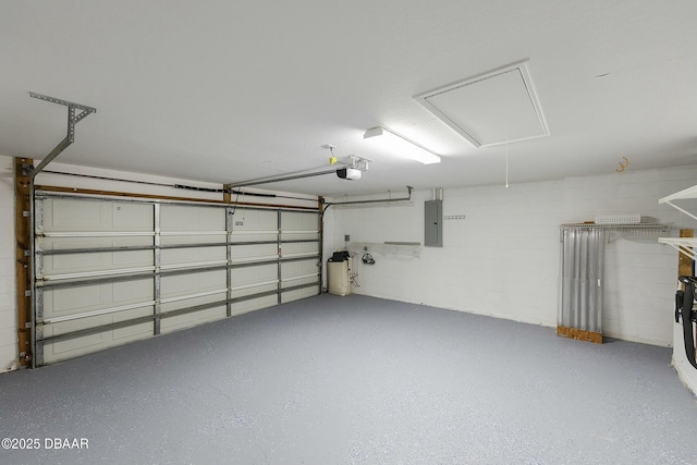 garage with concrete block wall and electric panel