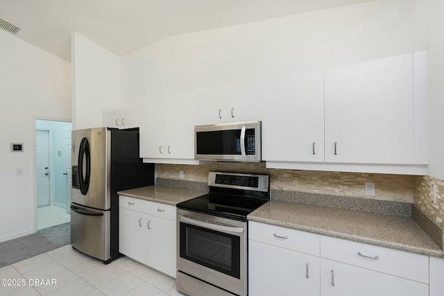 kitchen with stainless steel appliances, visible vents, white cabinetry, and light tile patterned flooring