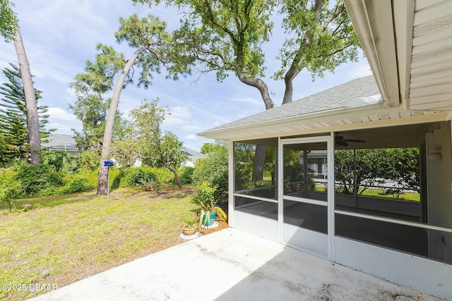 view of patio featuring a sunroom and ceiling fan