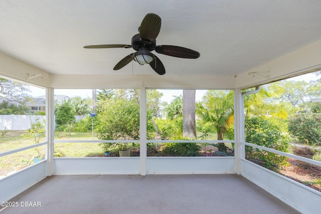 unfurnished sunroom featuring ceiling fan