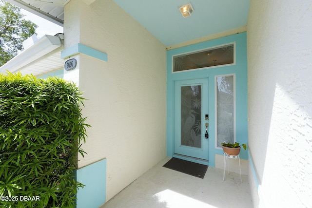 property entrance with stucco siding
