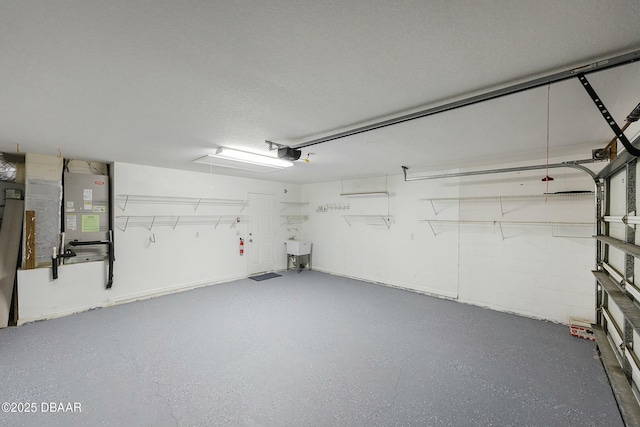 garage with a sink and a garage door opener