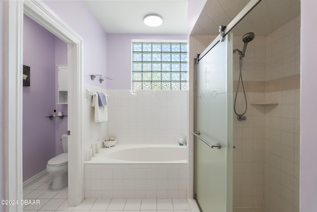 full bath featuring tile patterned flooring, a shower stall, toilet, and a bath