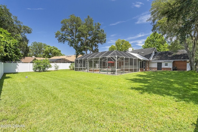 view of yard featuring a lanai and a fenced backyard