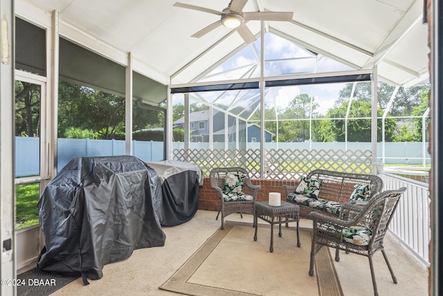 sunroom / solarium featuring lofted ceiling and a ceiling fan