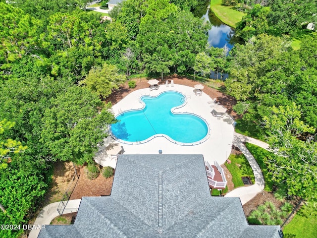 pool featuring a patio area and a water view