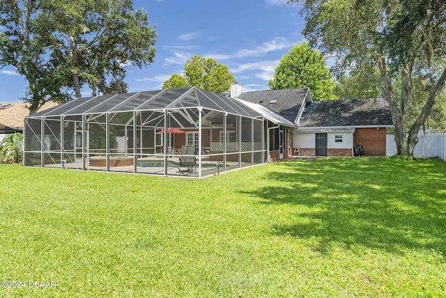 back of property featuring a patio area, a chimney, an outdoor pool, and a yard