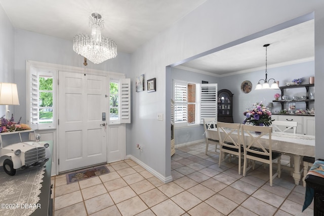 entrance foyer with plenty of natural light, baseboards, a notable chandelier, and light tile patterned flooring