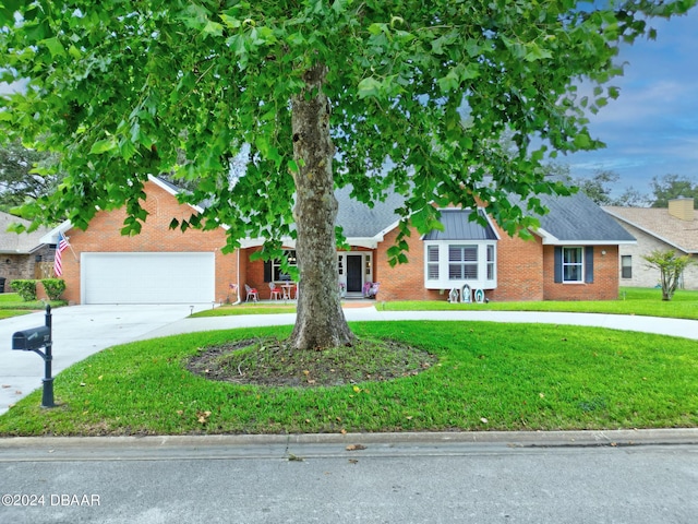 ranch-style home featuring brick siding, concrete driveway, and a front yard