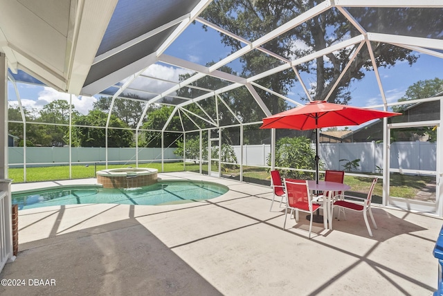 view of swimming pool with glass enclosure, a patio area, a fenced backyard, and a pool with connected hot tub