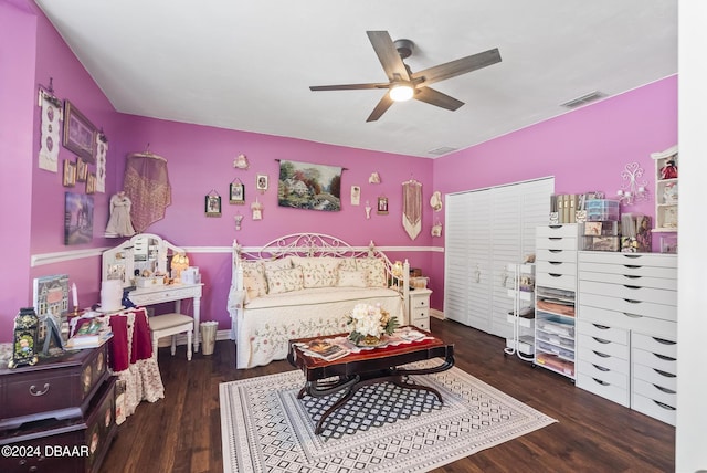 bedroom featuring baseboards, wood finished floors, visible vents, and a ceiling fan