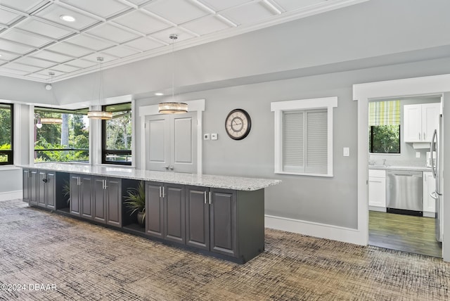 kitchen featuring light stone counters, a center island, decorative light fixtures, dishwasher, and baseboards